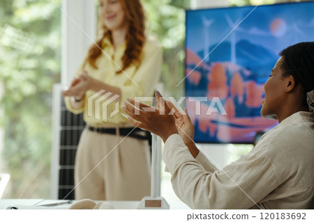 Woman Applauding To Colleague At Presentation 120183692