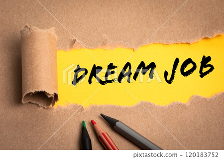 DREAM JOB. Torn cardboard and pencils on a yellow background 120183752