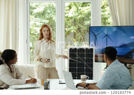 Woman Giving Presentation Of Solar Battery To Colleagues Woman Giving Presentation Of Solar Battery To Colleagues 120183774