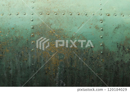 A fragment of the aluminum fuselage of an old aircraft. Old dirty fuselage with traces of corrosion.  120184029