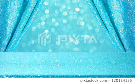 Light blue table and sparkling glitter curtain background 120184156