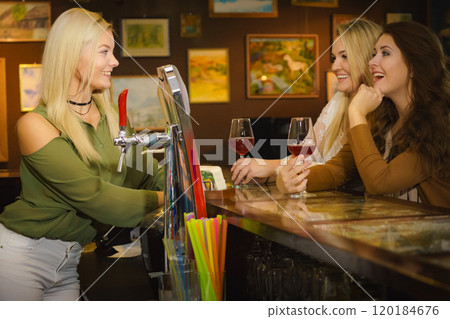 Young women in pub club at counter Young women in pub club at counter 120184676