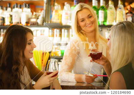 Girls with alcohol glasses in pub club 120184690