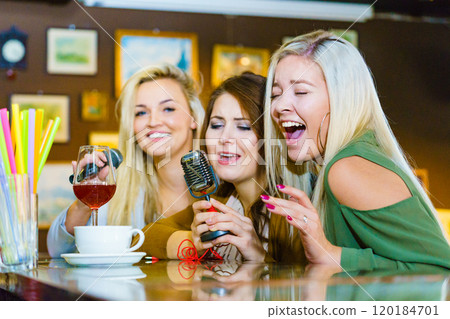 Women singing with microphone 120184701