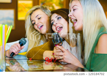 Women singing with microphone Women singing with microphone 120184702