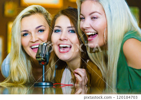 Women singing with microphone 120184703