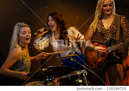 Woman singing, band playing instruments. Woman singing, band playing instruments. 120184720