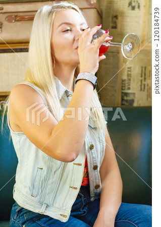 Girl with alcohol glass in pub club 120184739