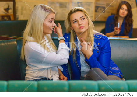 Women gossiping about friend Women gossiping about friend 120184763