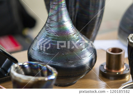 Model printed on 3D printer from metal. Object created on 3D printer from melting metal thread. Modern new technologies. Additive progressive manufacturing solution. Metal 3d printing technology Model printed on 3D printer from metal. Object created on 3D printer from melting metal thread. Modern new technologies. Additive progressive manufacturing solution. Metal 3d printing technology 120185582