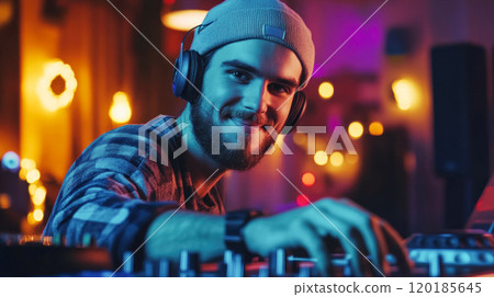 Young DJ mixing music in night club Young DJ mixing music in night club 120185645