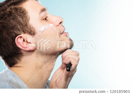 Man shaving with razor face profile Man shaving with razor face profile 120185903