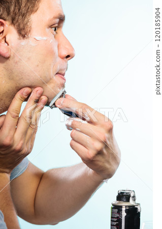 Man shaving with razor face profile 120185904