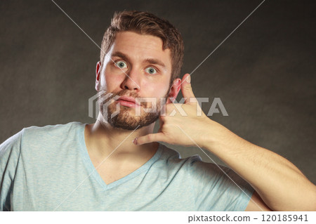 Surprised man showing call me gesture. 120185941