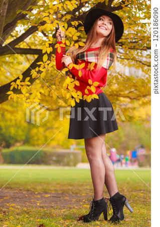 Beautiful woman in autumn park 120186090