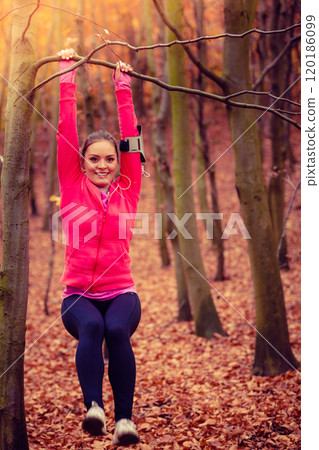 Young sporty girl doing exercises in forest. 120186099