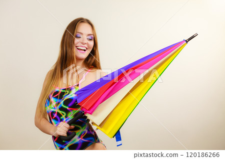 Happy woman posing in swimsuit and colorful umbrella 120186266
