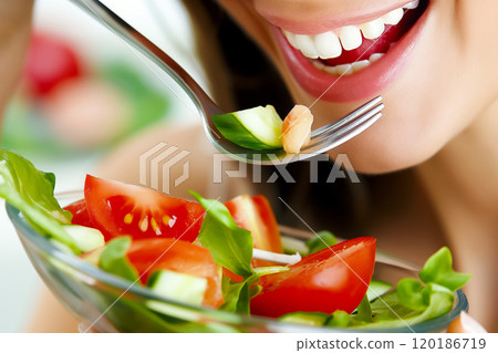 Woman eating salad with fork close-up, healthy eating concept 120186719