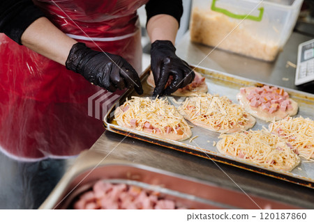 Preparing homemade ham and cheese pastries in a professional kitchen for baking perfection Preparing homemade ham and cheese pastries in a professional kitchen for baking perfection 120187860