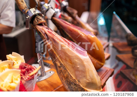 Legs of traditional Spanish jamon ready for sale in grocery. Dry Spanish ham, Jamon Serrano, Bellota. Different ham jamon serrano legs 120187908