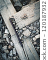wooden beams bound with iron on stones 120187932