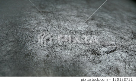 Textured Surface With Scratches and Marks Captures Light in an Abstract Setting Textured Surface With Scratches and Marks Captures Light in an Abstract Setting 120188731