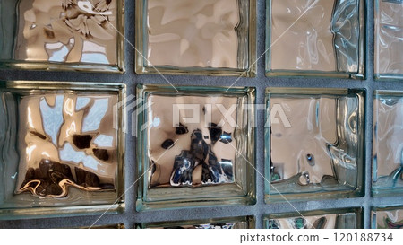 Reflections on Textured Glass Block Wall in Urban Setting During Daylight 120188734
