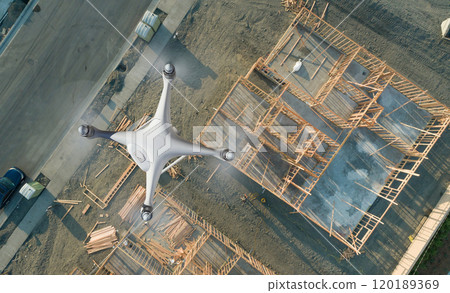 Unmanned Aircraft System Quadcopter Drone UAV In The Air Over Construction Site. Unmanned Aircraft System Quadcopter Drone UAV In The Air Over Construction Site. 120189369
