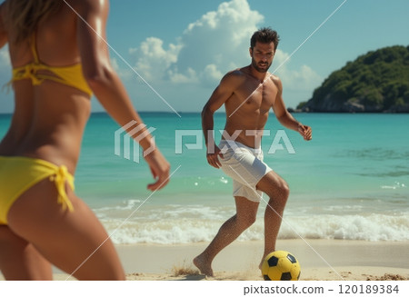 A man in white shorts plays soccer on a beautiful beach while a woman in a yellow bikini runs towards him. The scene captures the joy of summer, with clear turquoise waters and fluffy clouds creating 120189384