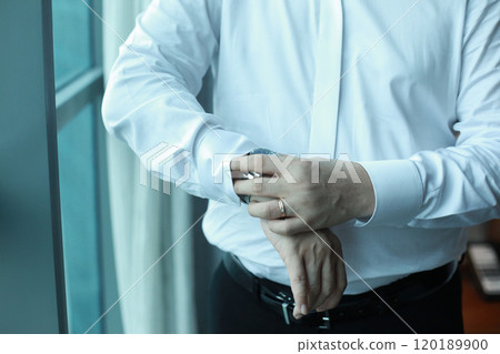 Professional man gestures, fine gentleman, business executive fitting to their suit and preparing for daily office job, dressing to gentleman suit good for executive magazine, executive concept 120189900