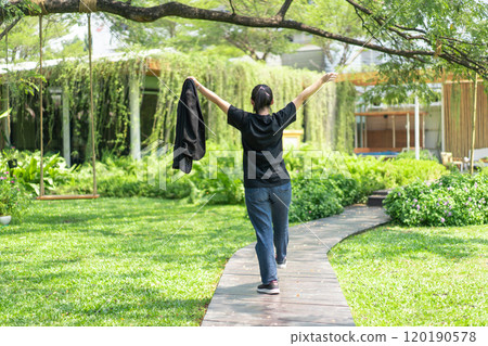 Portrait of the Asian glassese Thai woman is standing in the garden in the morning. Portrait of the Asian glassese Thai woman is standing in the garden in the morning. 120190578