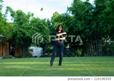Asian short hair Woman is Joyful Jumping on the grass field garden. 120190585
