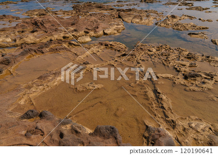 Coastal Rock Surface with Natural Erosion Patterns and Tidal Pools 120190641