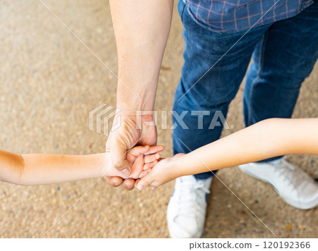 Close up of parent and baby join hands on the light background. Dad And two children joined hand together. Father holding hands of cute children. Close up of parent and baby join hands on the light background. Dad And two children joined hand together. Father holding hands of cute children. 120192366