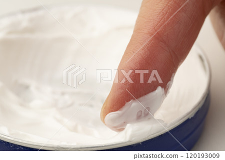 Close-up of hands applying hand cream Close-up of hands applying hand cream 120193009