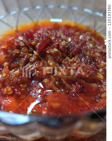Super spicy red shrimp paste chili sauce on a clear bowl Super spicy red shrimp paste chili sauce on a clear bowl 120193360