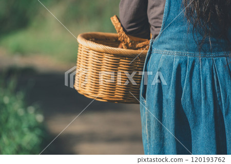 Woman with woven basket 120193762
