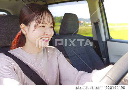 Smiling young woman driving Smiling young woman driving 120194498