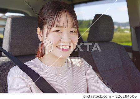 Smiling young woman driving Smiling young woman driving 120194500