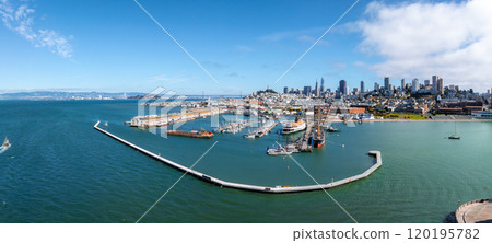 Aerial view of San Francisco featuring the Transamerica Pyramid, Salesforce Tower, marina, historic ships, and Golden Gate Bridge in the distance. 120195782