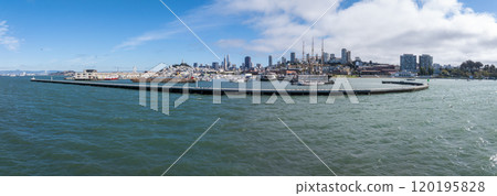 San Francisco skyline featuring Transamerica Pyramid and Salesforce Tower. Historic ships at Hyde Street Pier in foreground with calm bay waters. 120195828