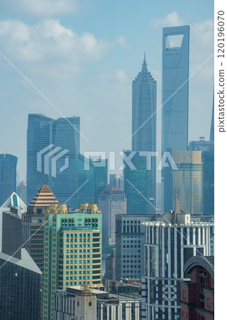 View of Shanghai's skyline with the Shanghai World Financial Center and Jin Mao Tower. Modern skyscrapers and traditional designs under a clear blue sky. View of Shanghai's skyline with the Shanghai World Financial Center and Jin Mao Tower. Modern skyscrapers and traditional designs under a clear blue sky. 120196070