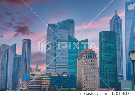 The image displays Shanghai's Pudong district skyline, highlighting the Shanghai World Financial Center and Jin Mao Tower against a pink and blue sky. The image displays Shanghai's Pudong district skyline, highlighting the Shanghai World Financial Center and Jin Mao Tower against a pink and blue sky. 120196372