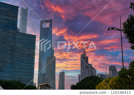 Shanghai's skyline at sunset features the Shanghai World Financial Center. Vibrant pink, purple, and orange hues fill the sky above modern skyscrapers. Shanghai's skyline at sunset features the Shanghai World Financial Center. Vibrant pink, purple, and orange hues fill the sky above modern skyscrapers. 120196413