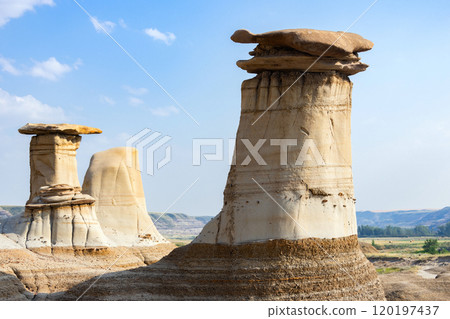 Sandstone hoodoos created by erosion in scenic badlands in summer. 120197437
