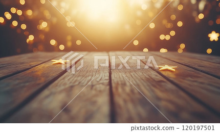 Golden stars on a wooden table with a magical bokeh background illuminated by sunset. 120197501