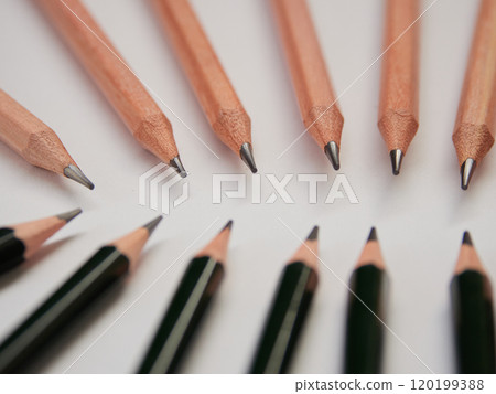 White paper with green and wooden pencils lined up 120199388