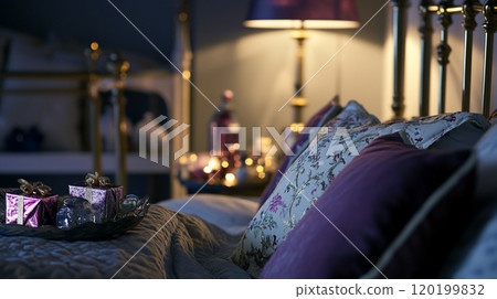 Bed and pillows in bedroom with Christmas tree and holiday decorations 120199832