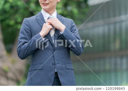 A businessman doing a tie A businessman doing a tie 120199843