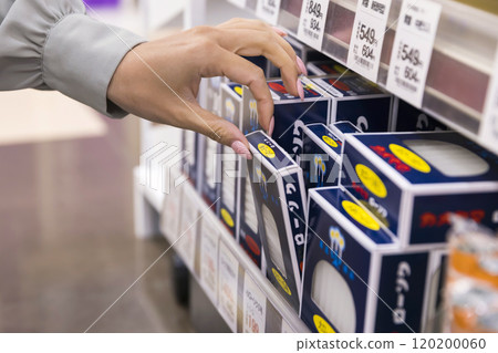 Woman buying candles at the supermarket Woman buying candles at the supermarket 120200060